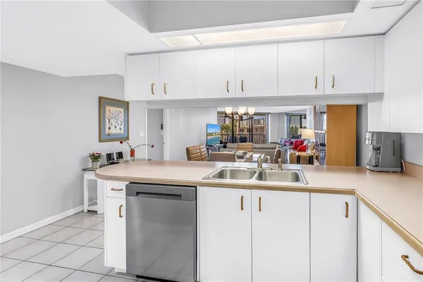 a kitchen with kitchen island granite countertop a sink a stove and cabinets