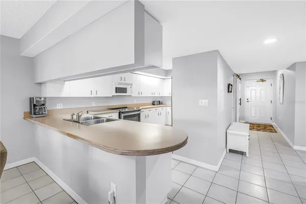 a kitchen with stainless steel appliances granite countertop a sink and a refrigerator