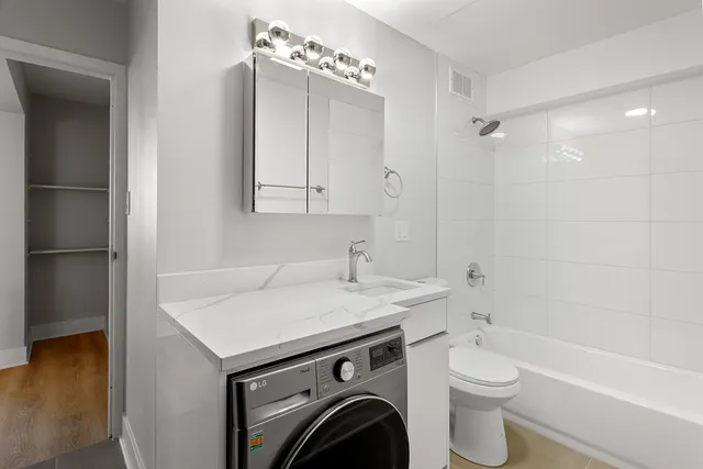 a view of bathroom with a sink mirror and toilet