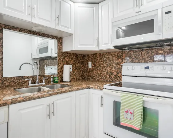 a kitchen with granite countertop a sink and a stove