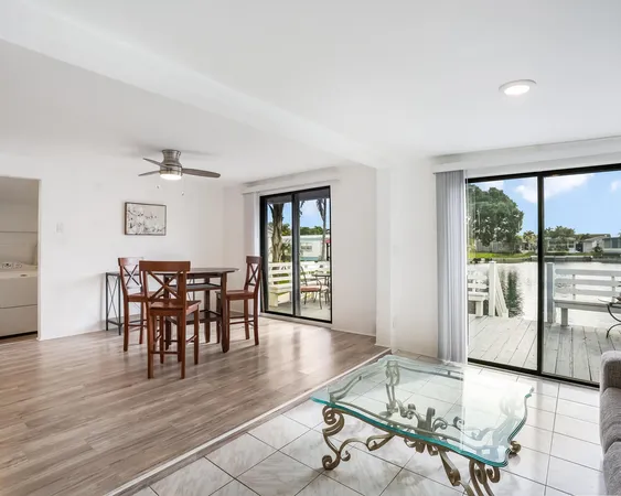 a room with furniture pool table and glass door