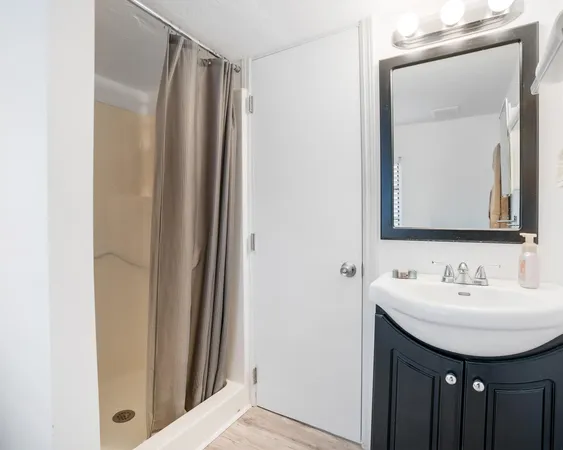 a bathroom with a sink a mirror and a vanity