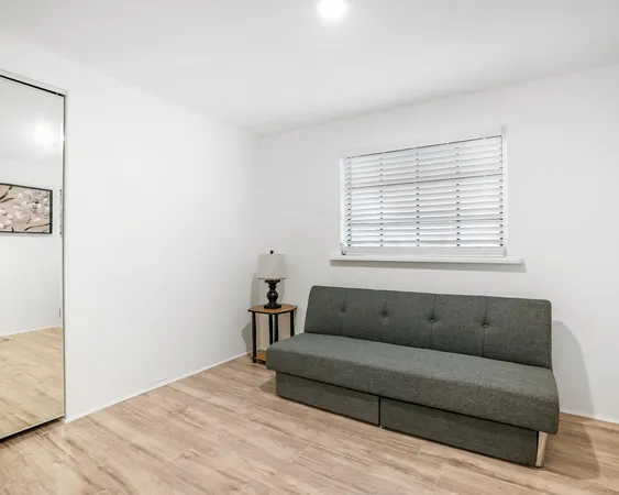 a living room with a couch and a window
