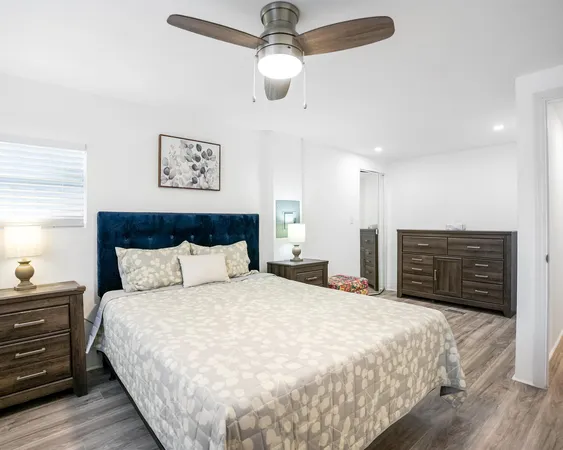 a large bed in a bedroom with a chandelier