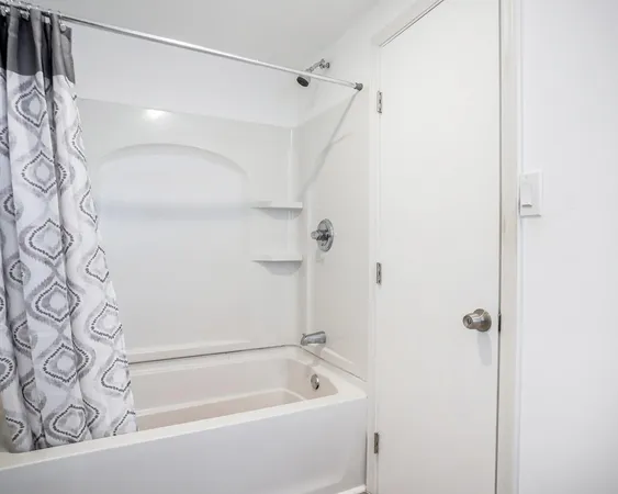 a bathroom with a bathtub and shower