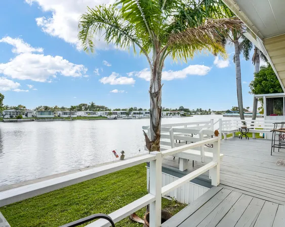 a view of a lake with couches in the patio