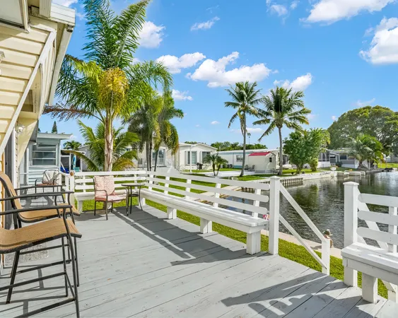 a view of a swimming pool with a lawn chairs under an umbrella