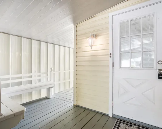 a view of wooden floor and windows in a room