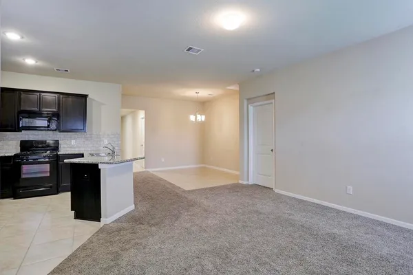 a large kitchen with kitchen island granite countertop a sink and a stove top oven