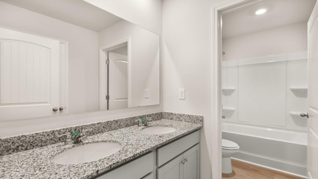 113 Crooked Lk Park Villa Rica, GA 30180 - Photo 24 of 30 a bathroom with a granite countertop sink and a mirror