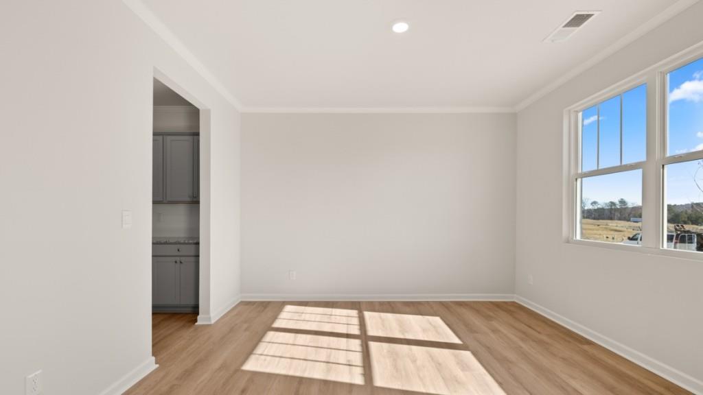 113 Crooked Lk Park Villa Rica, GA 30180 - Photo 3 of 30 a view of an empty room with a window and wooden floor