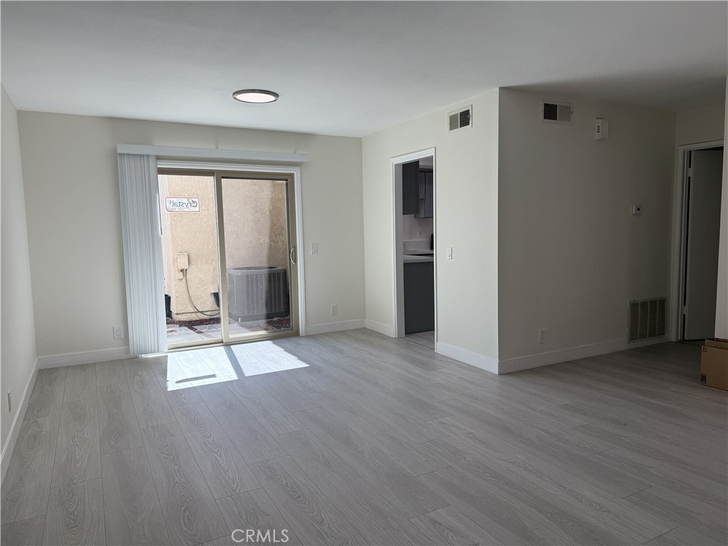 9860 Galena Court Rancho Cucamonga, CA 91730 - Photo 2 of 6 an empty room with wooden floor and windows