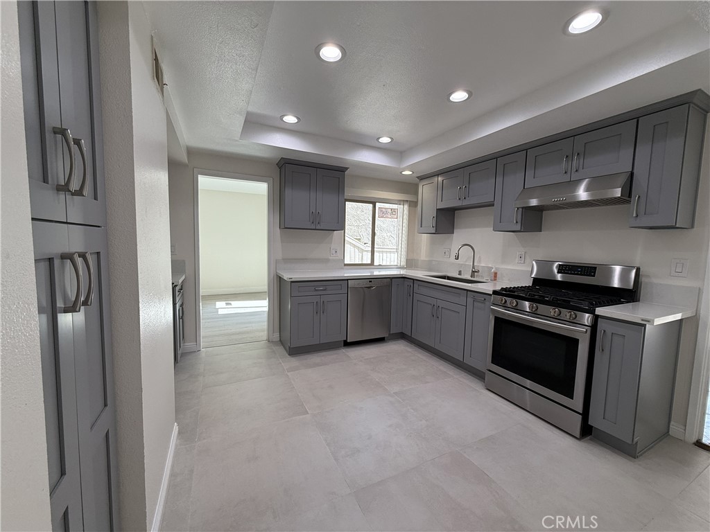 9860 Galena Court Rancho Cucamonga, CA 91730 - Photo 3 of 6 a large kitchen with stainless steel appliances granite countertop a stove a sink and a refrigerator