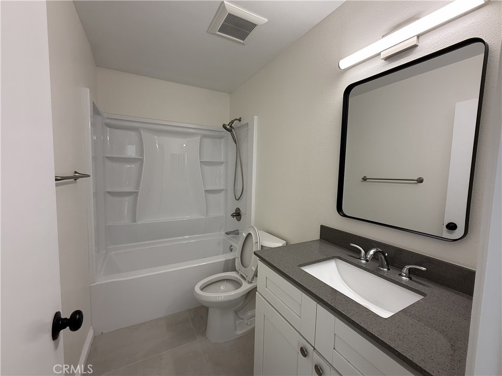 9860 Galena Court Rancho Cucamonga, CA 91730 - Photo 4 of 6 a bathroom with a granite countertop sink toilet and shower