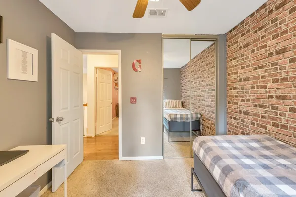 a bedroom with a bed and a dresser