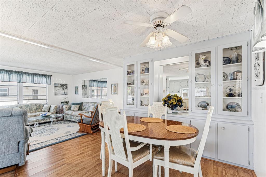 13225 101st Street Southeast, Unit 222 Largo, FL 33773 - Photo 11 of 73 a dining room with wooden floor and chandelier