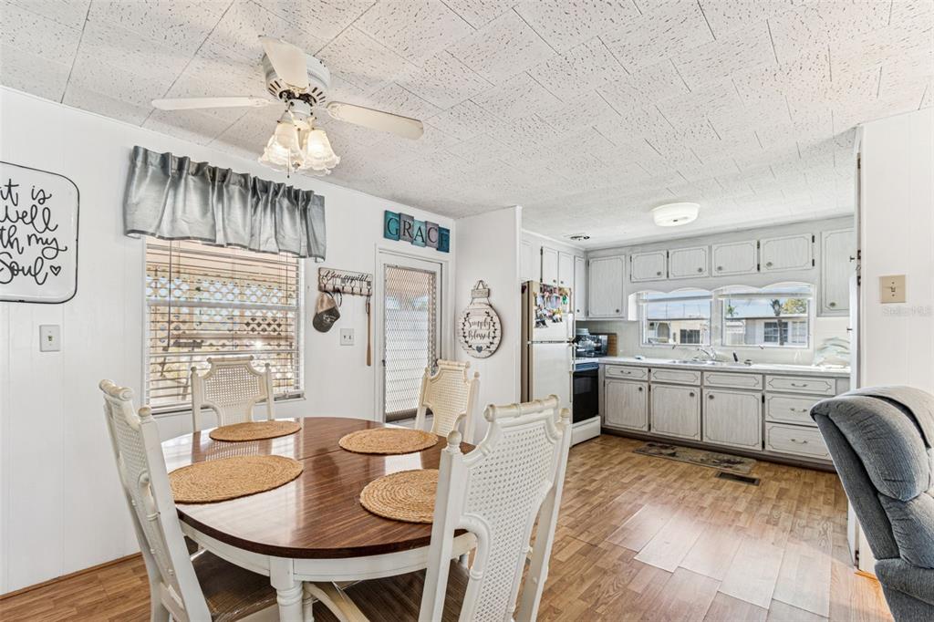 13225 101st Street Southeast, Unit 222 Largo, FL 33773 - Photo 14 of 73 a kitchen with cabinets a table and chairs in it