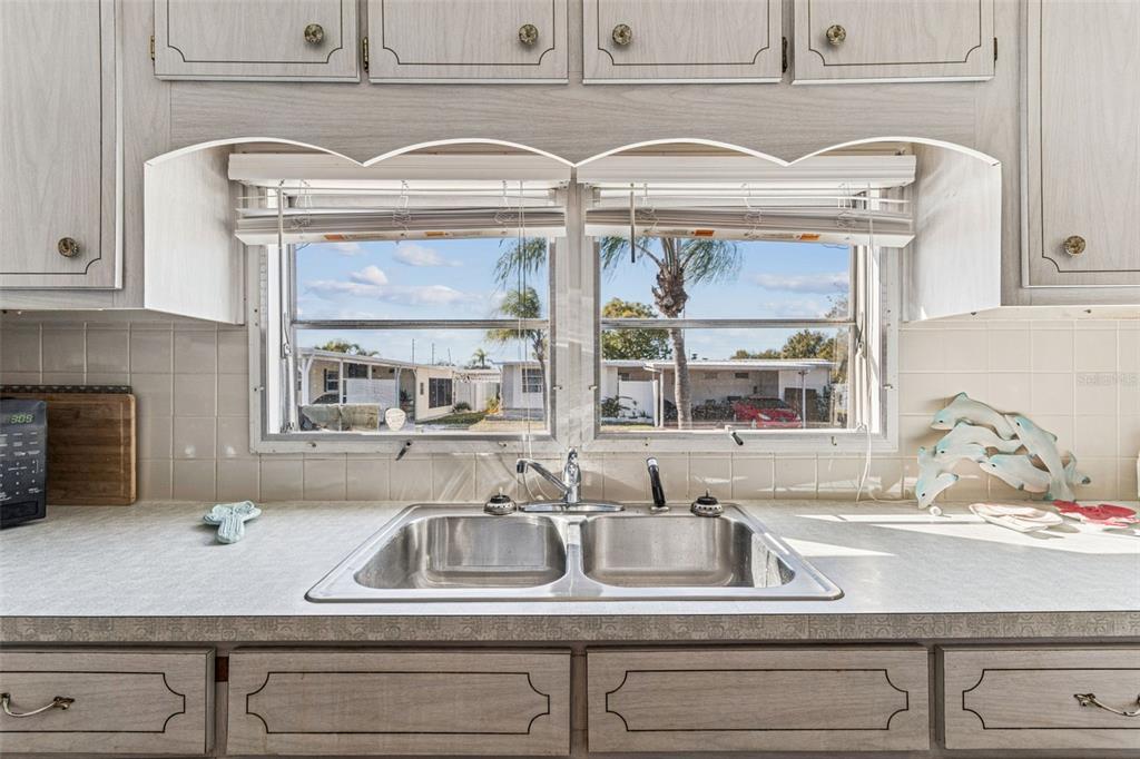 13225 101st Street Southeast, Unit 222 Largo, FL 33773 - Photo 20 of 73 a kitchen sink with granite countertop cabinets