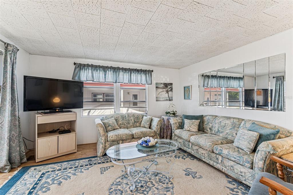 13225 101st Street Southeast, Unit 222 Largo, FL 33773 - Photo 26 of 73 a living room with furniture and a flat screen tv