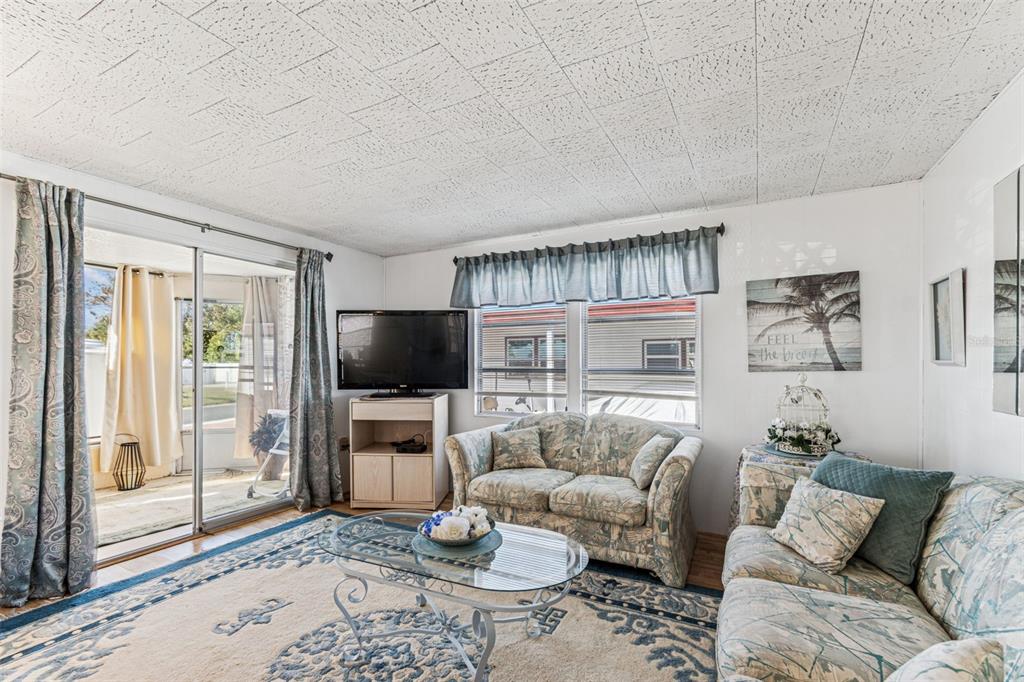13225 101st Street Southeast, Unit 222 Largo, FL 33773 - Photo 27 of 73 a living room with furniture and a flat screen tv