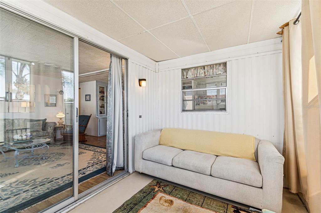 13225 101st Street Southeast, Unit 222 Largo, FL 33773 - Photo 30 of 73 a living room with furniture and a glass door