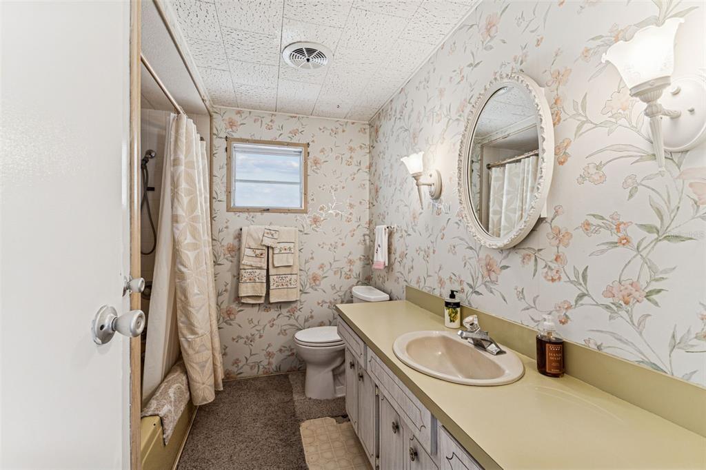 13225 101st Street Southeast, Unit 222 Largo, FL 33773 - Photo 34 of 73 a bathroom with a granite countertop sink mirror vanity and toilet
