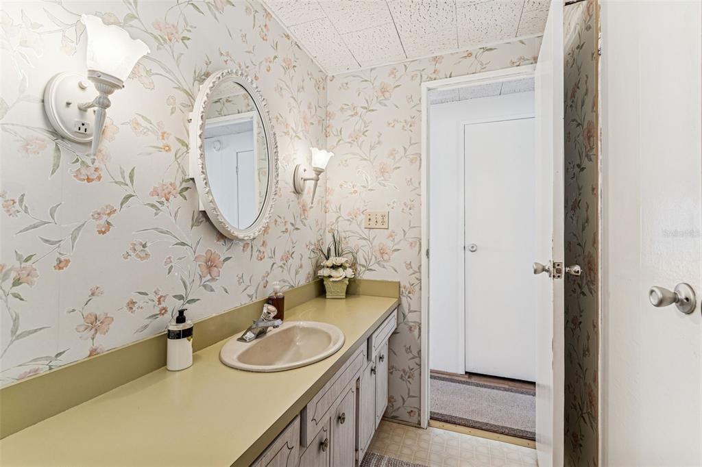 13225 101st Street Southeast, Unit 222 Largo, FL 33773 - Photo 35 of 73 a bathroom with a sink and a mirror