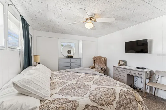 a front view of a house with swimming pool and porch with furniture
