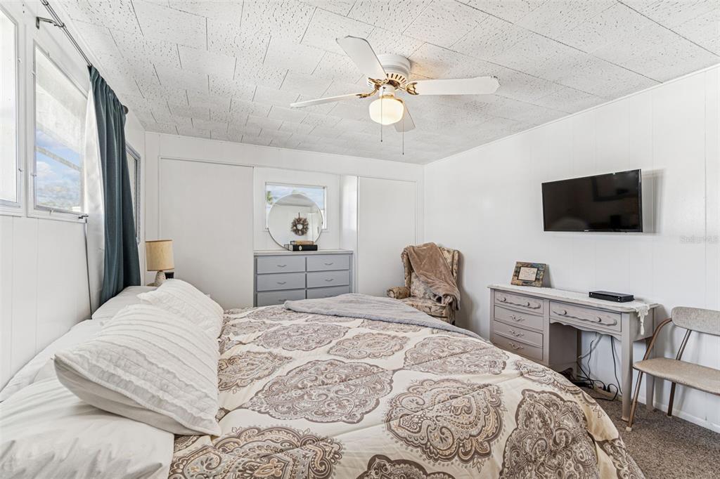 13225 101st Street Southeast, Unit 222 Largo, FL 33773 - Photo 37 of 73 a bedroom with a bed and a flat screen tv