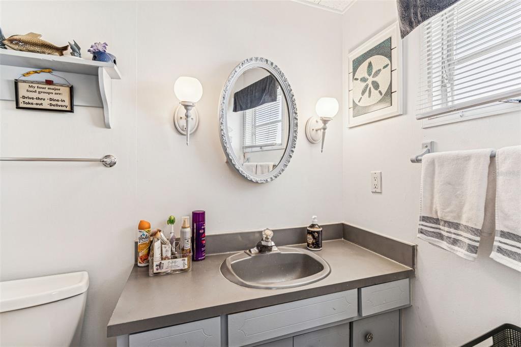 13225 101st Street Southeast, Unit 222 Largo, FL 33773 - Photo 41 of 73 a bathroom with a toilet a sink and a mirror