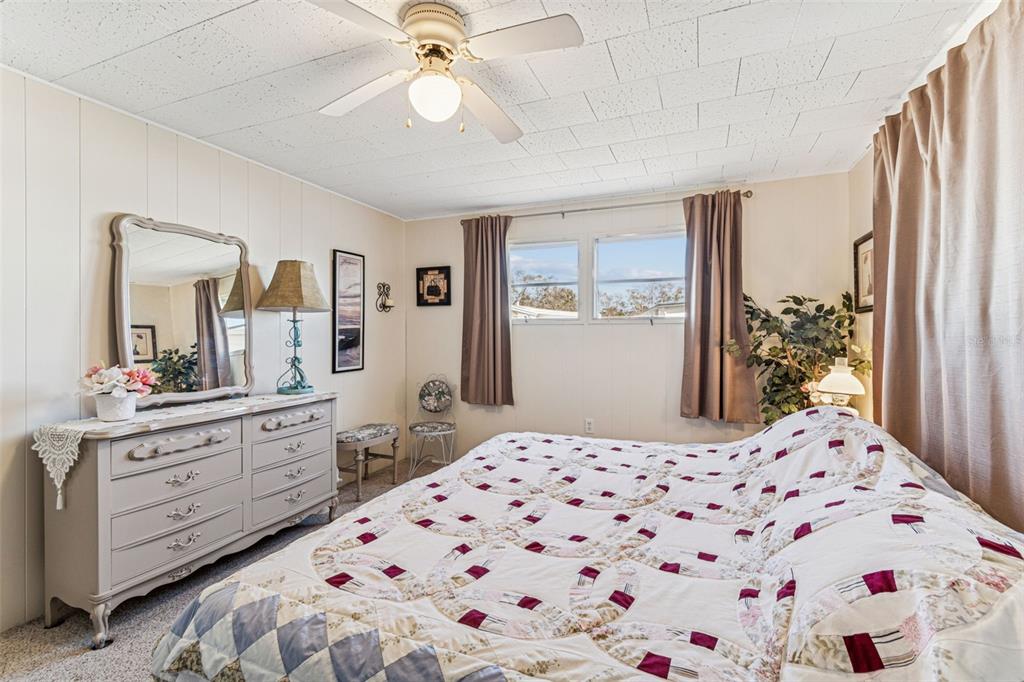 13225 101st Street Southeast, Unit 222 Largo, FL 33773 - Photo 44 of 73 a bedroom with a bed and a dresser