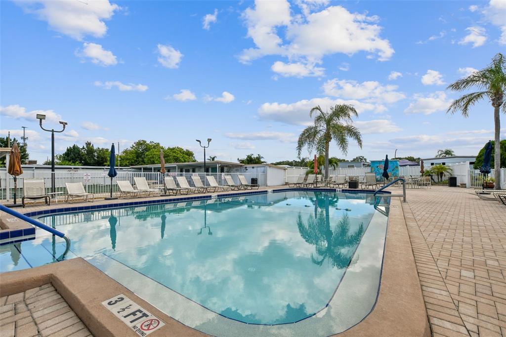 13225 101st Street Southeast, Unit 222 Largo, FL 33773 - Photo 69 of 73 a view of a swimming pool with outdoor seating