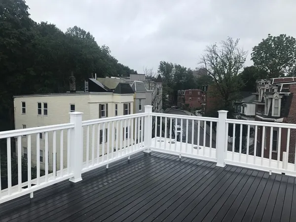 a view of a wooden deck and a yard