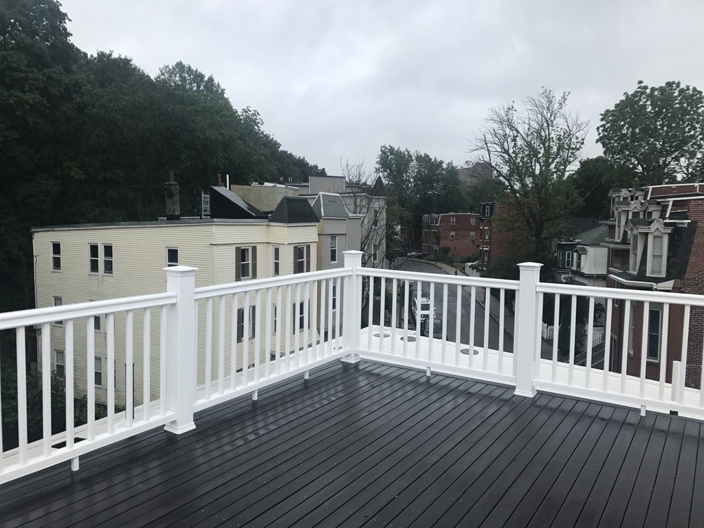 140 Marcella Street, Unit 4 Boston, MA 02119 - Photo 1 of 14 a view of a wooden deck and a yard