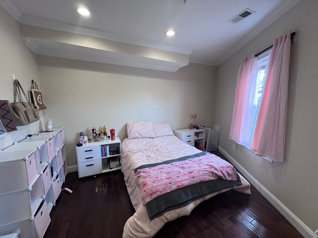 140 Marcella Street, Unit 4 Boston, MA 02119 - Photo 11 of 14 a bedroom with a bed and a window