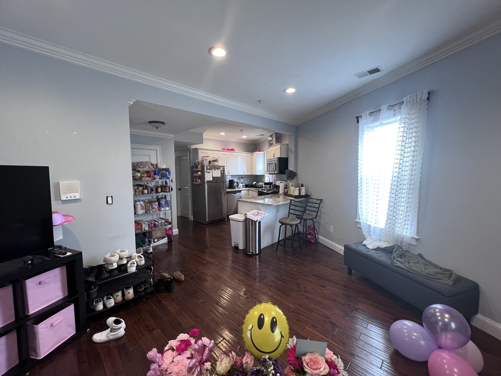 140 Marcella Street, Unit 4 Boston, MA 02119 - Photo 5 of 14 a living room with furniture and a flat screen tv