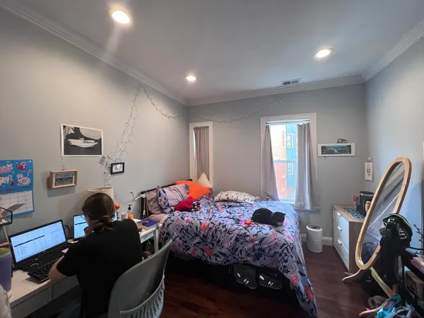 a bedroom with a bed and a window