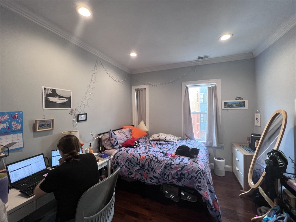 140 Marcella Street, Unit 4 Boston, MA 02119 - Photo 6 of 14 a bedroom with a bed and a window