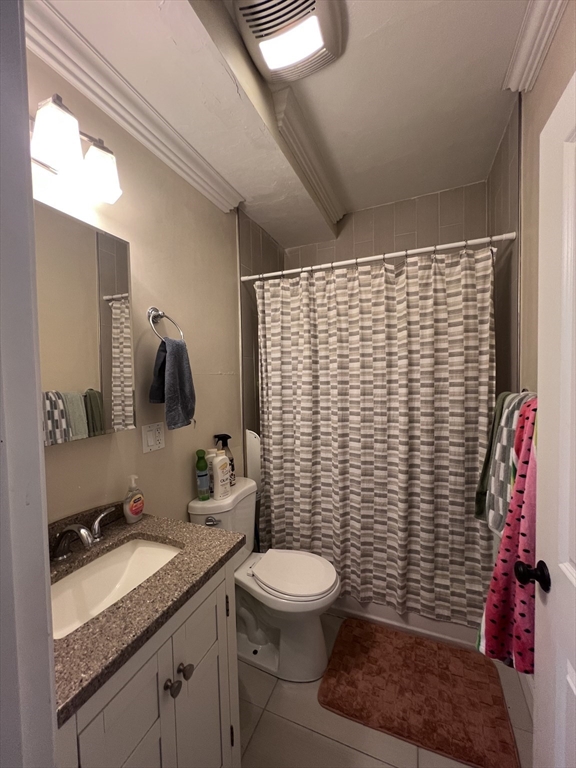 140 Marcella Street, Unit 4 Boston, MA 02119 - Photo 7 of 14 a bathroom with a granite countertop toilet sink and mirror