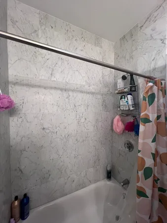 a bathroom with a bathtub and shower