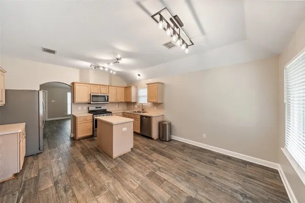 a kitchen with refrigerator and cabinets