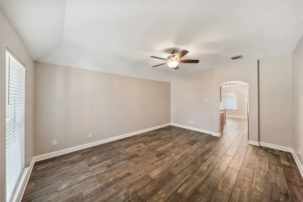 wooden floor in an empty room with a window