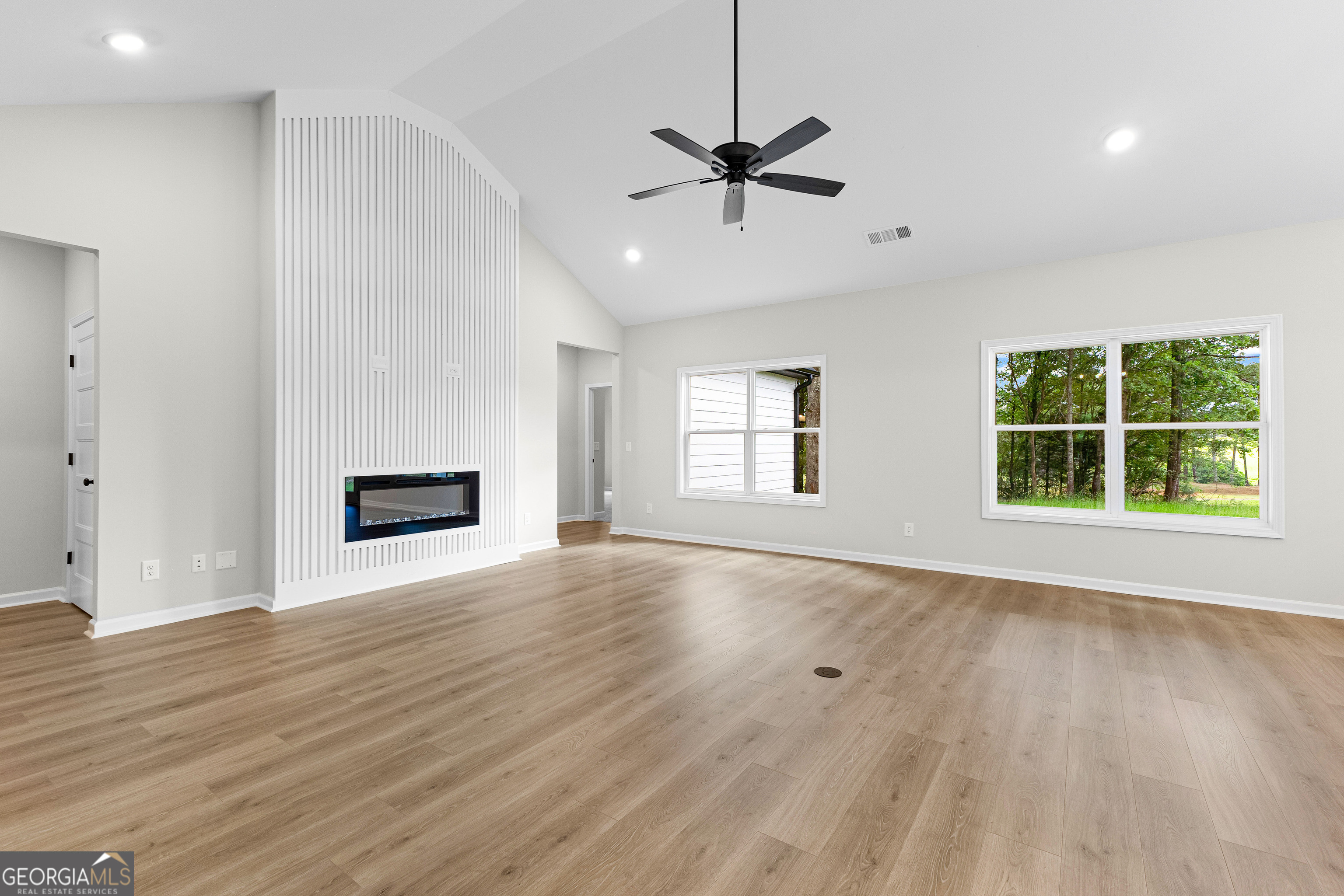 1210 Waymanville Road Thomaston, GA 30286 - Photo 12 of 45 a view of an empty room with wooden floor and a window