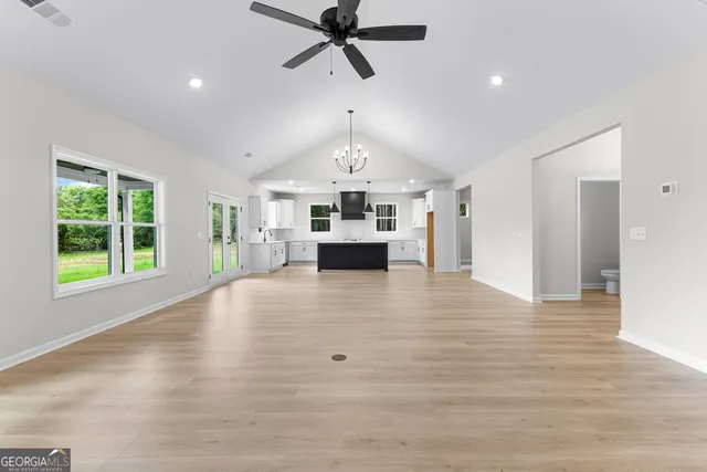 a view of livingroom with kitchen island furniture and windows