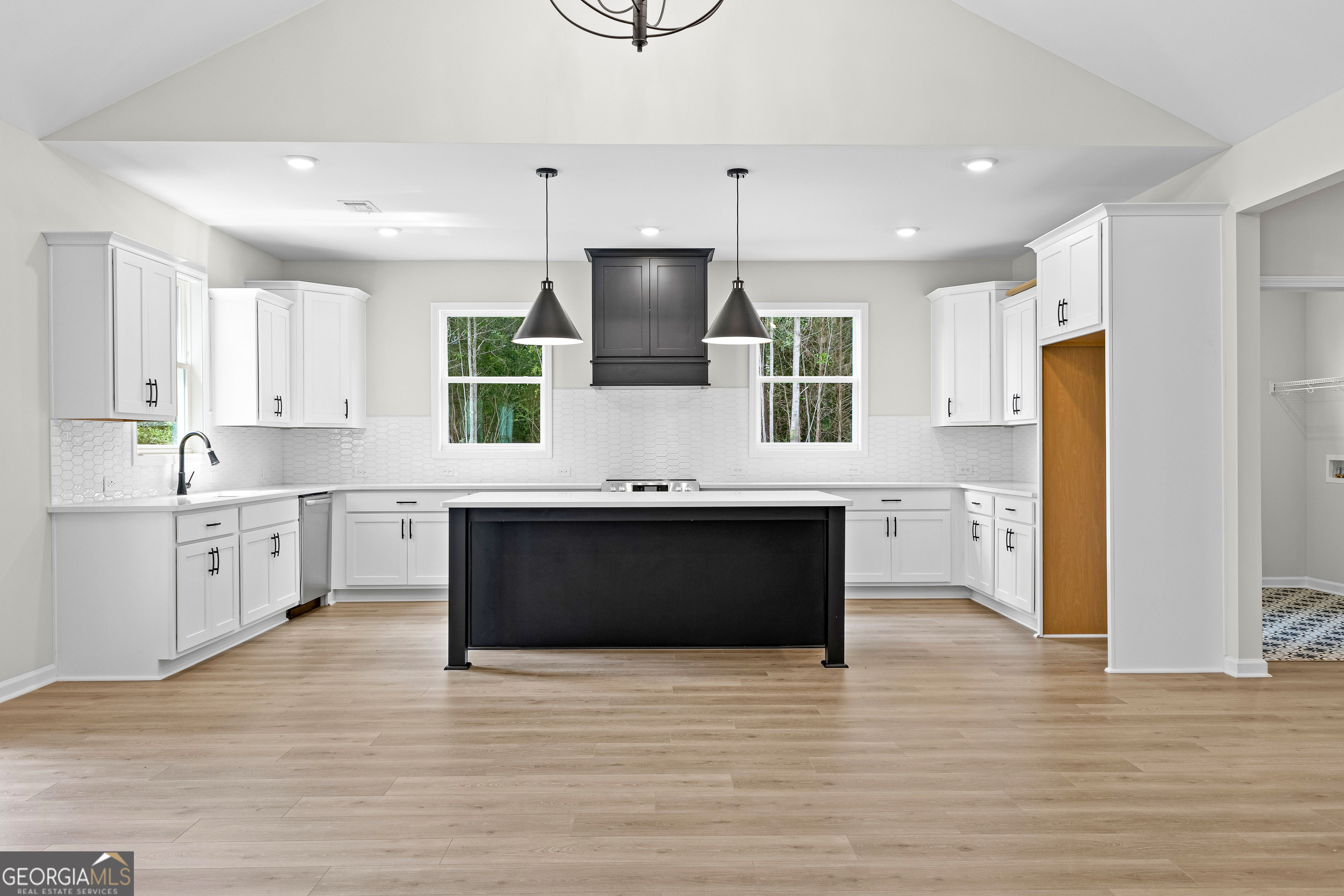 1210 Waymanville Road Thomaston, GA 30286 - Photo 14 of 45 a kitchen with stainless steel appliances kitchen island granite countertop a stove a sink and a refrigerator