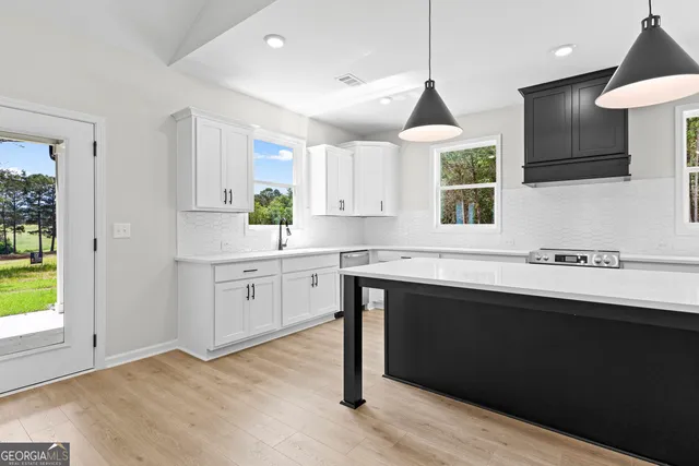a kitchen with a sink cabinets and window