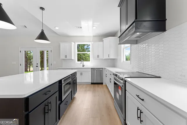 a kitchen with a sink stove and cabinets
