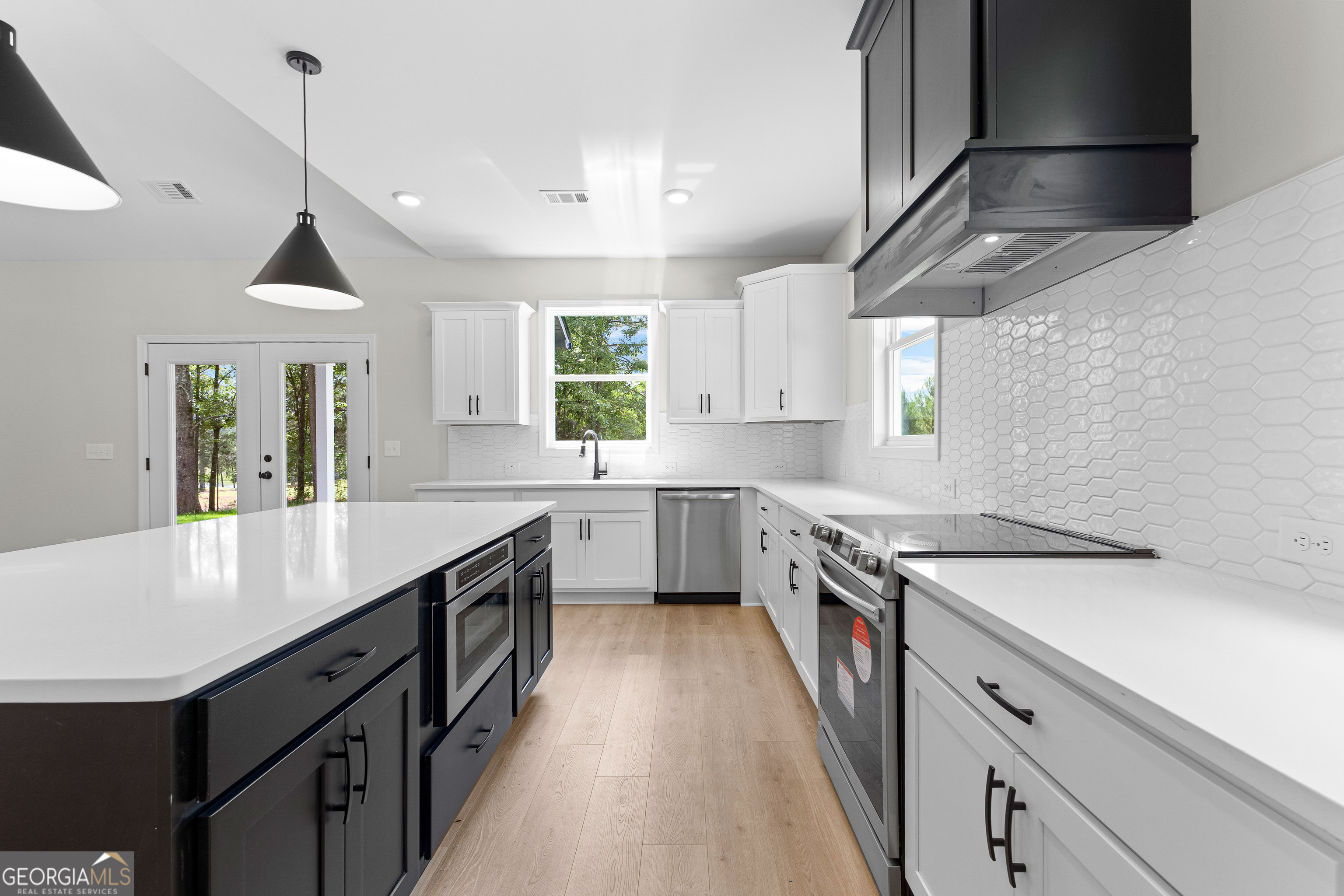 1210 Waymanville Road Thomaston, GA 30286 - Photo 16 of 45 a kitchen with a sink stove and cabinets