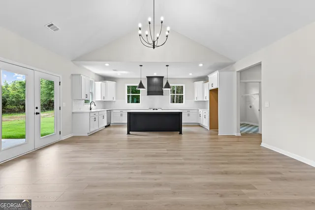 a view of a kitchen with a stove wooden cabinets and a kitchen