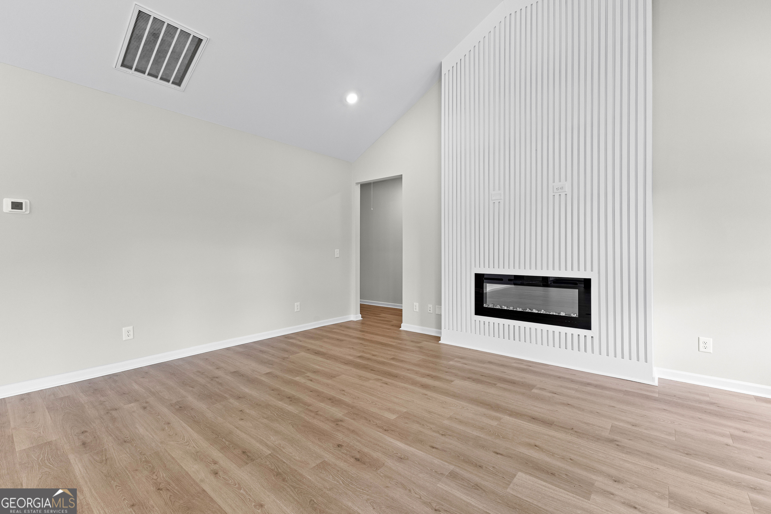 1210 Waymanville Road Thomaston, GA 30286 - Photo 22 of 45 a view of an empty room with wooden floor and a window